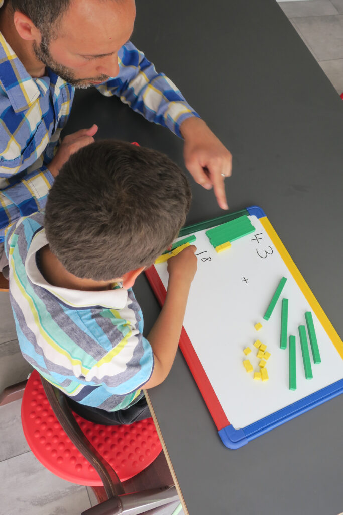 Working with a young student sitting on a wobble cushion